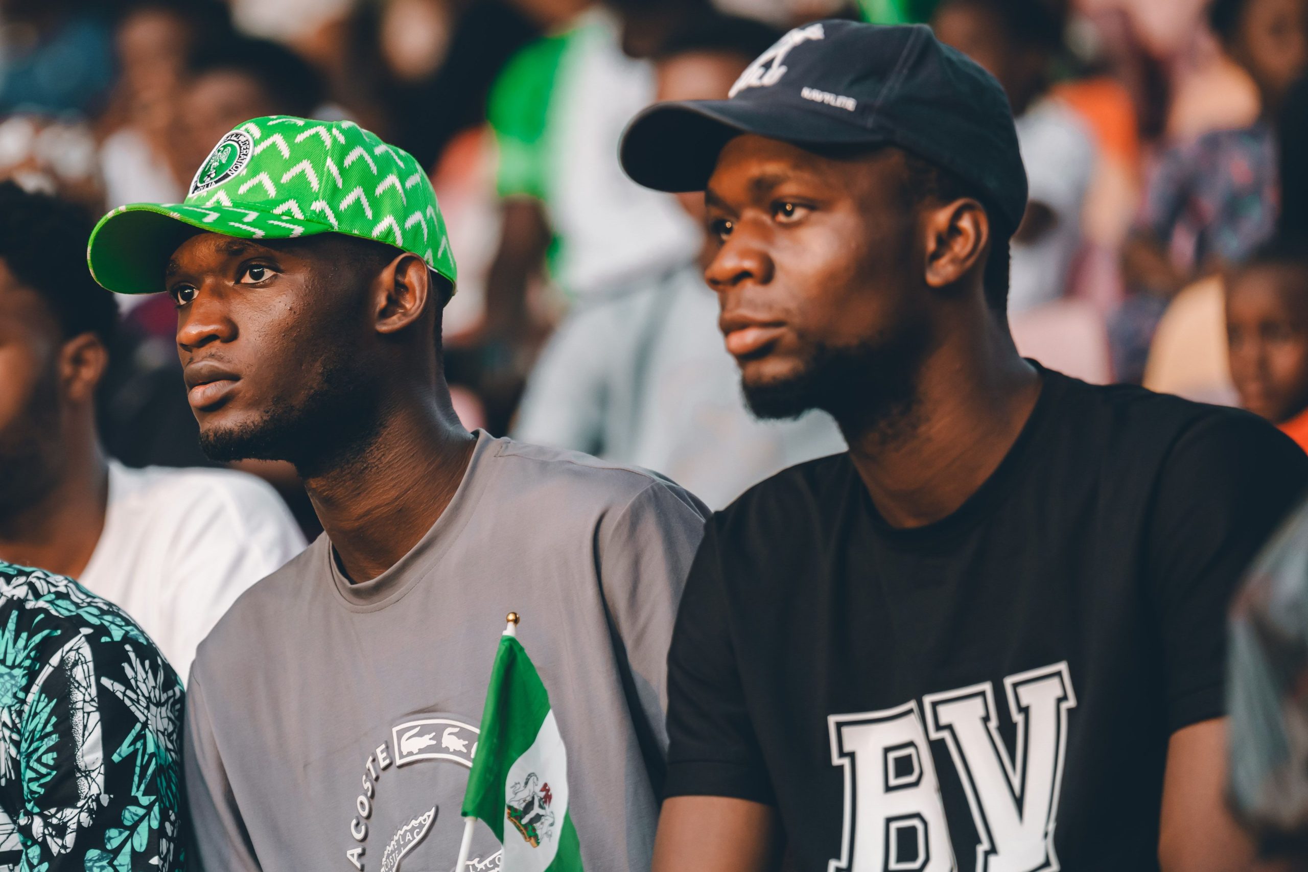 Capturing Nigerian football fans in vibrant green attire, showcasing cultural pride and excitement.