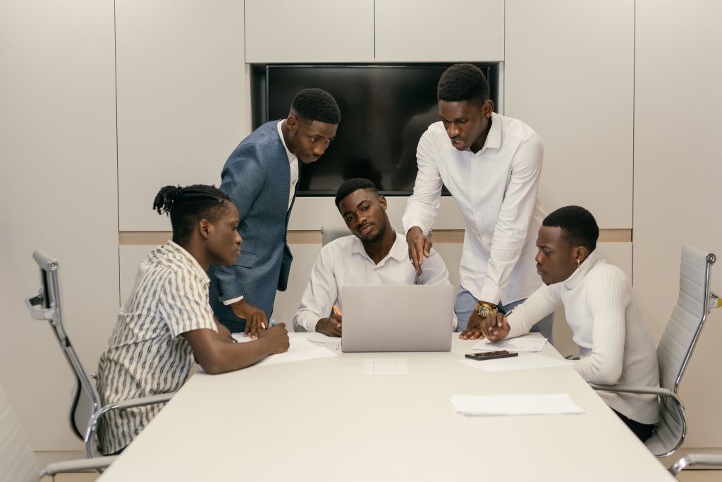 Young professionals brainstorming and collaborating in a modern conference room setting.